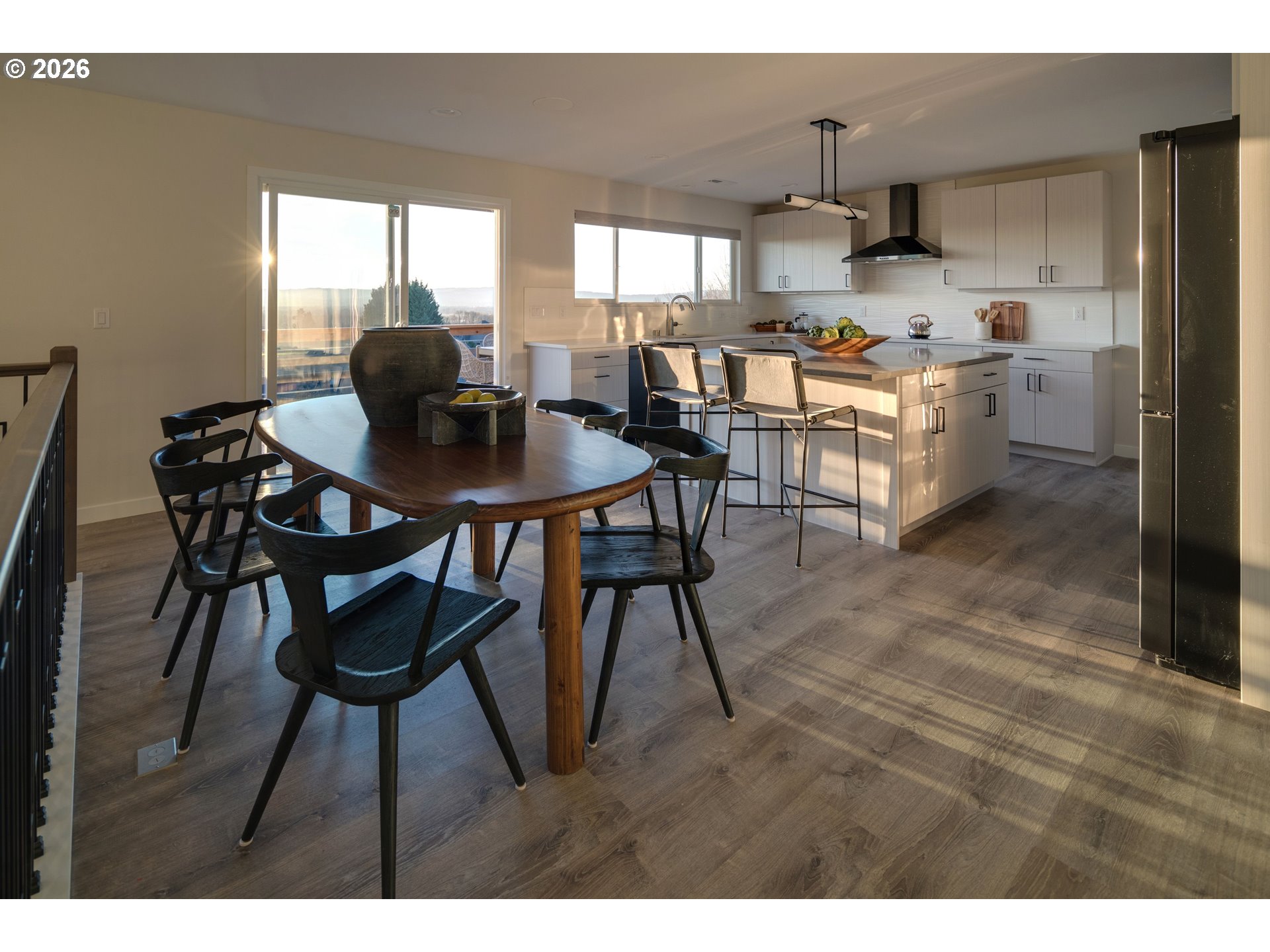 6409 Northwest 202nd Circle Ridgefield, WA 98642 - Photo 12 of 39 a kitchen with stainless steel appliances a table chairs and a refrigerator