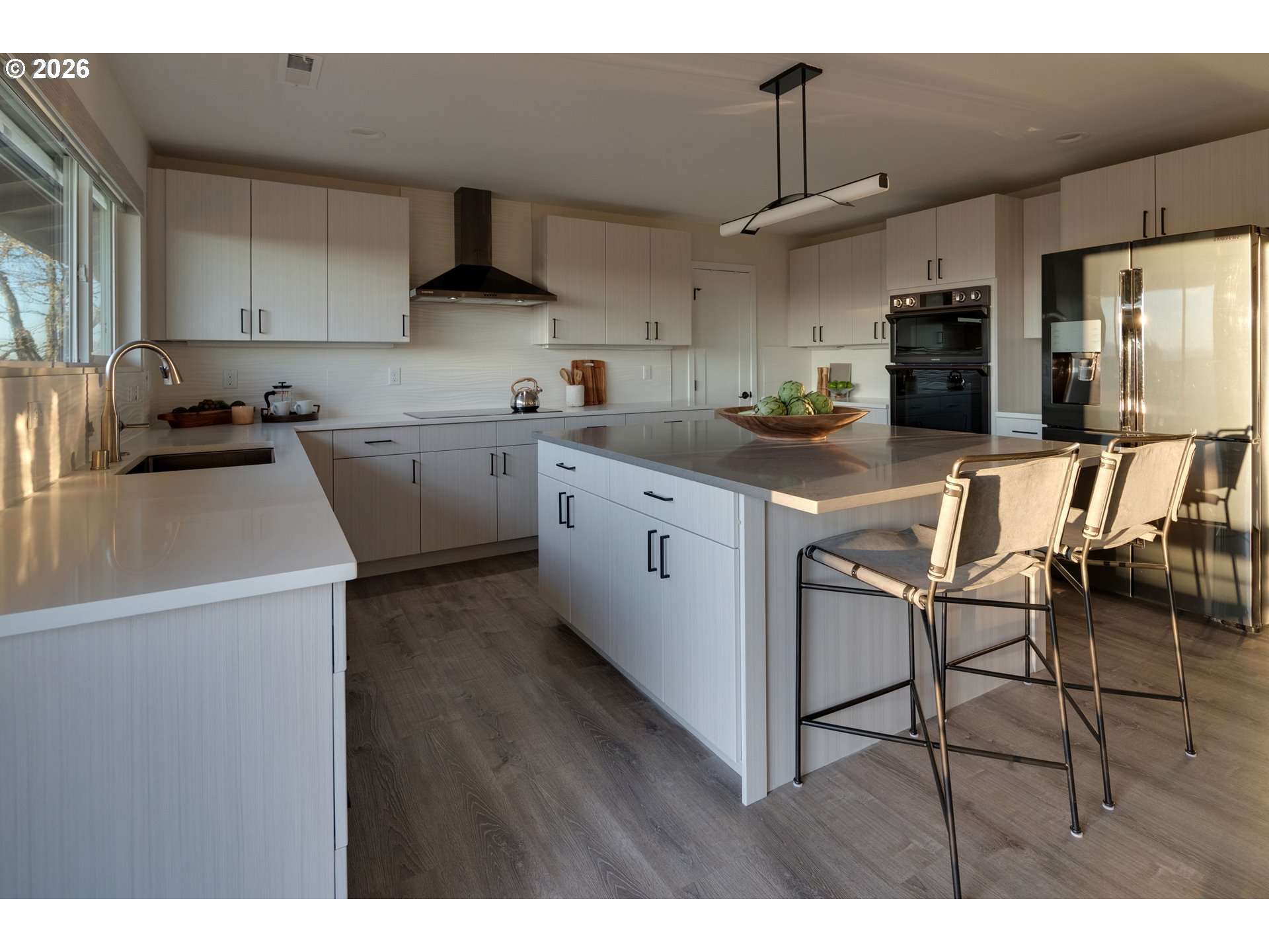 6409 Northwest 202nd Circle Ridgefield, WA 98642 - Photo 13 of 39 a kitchen with stainless steel appliances granite countertop a sink a stove a refrigerator cabinets and chairs
