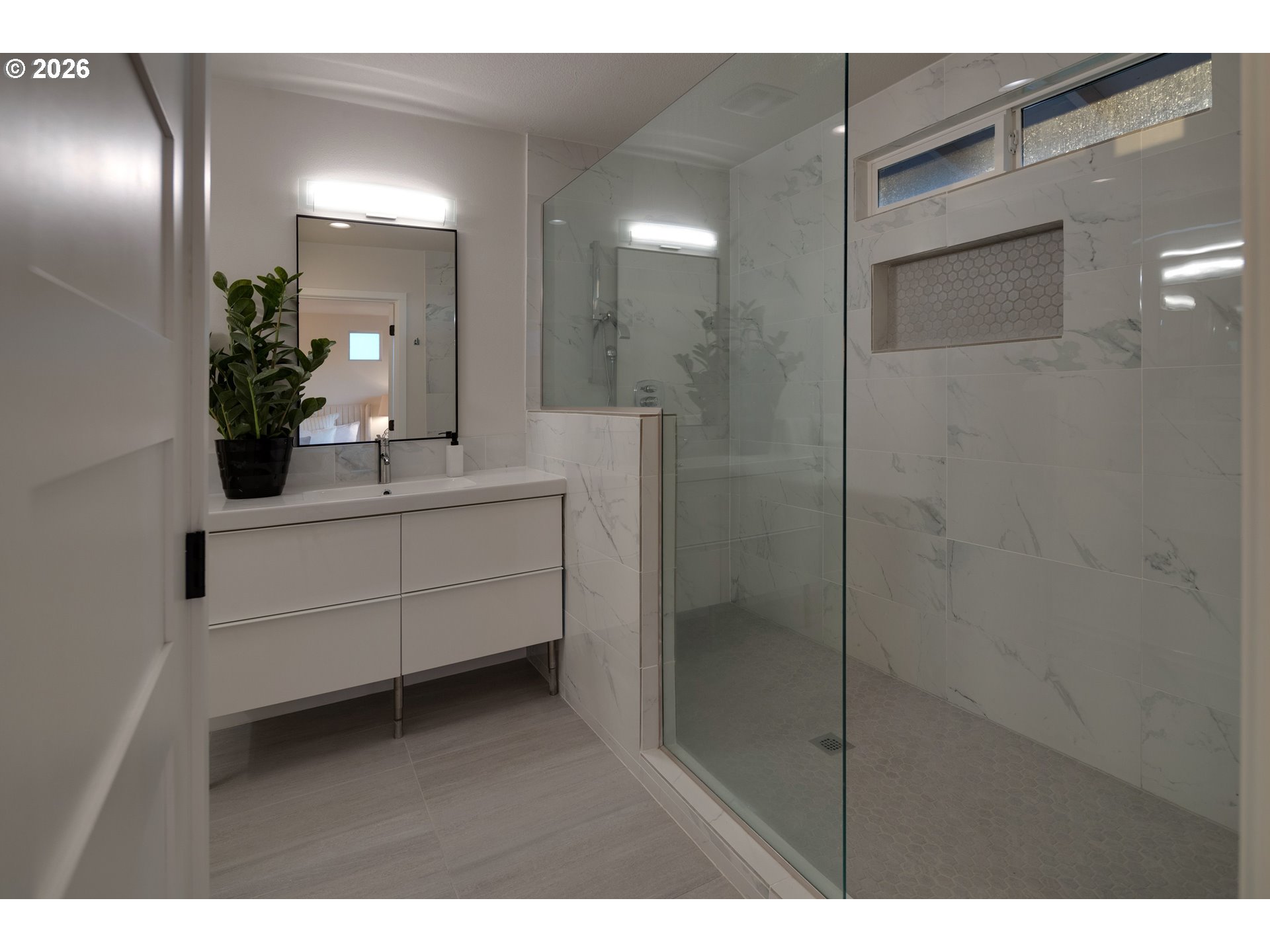 6409 Northwest 202nd Circle Ridgefield, WA 98642 - Photo 18 of 39 a bathroom with a sink a mirror and a shower