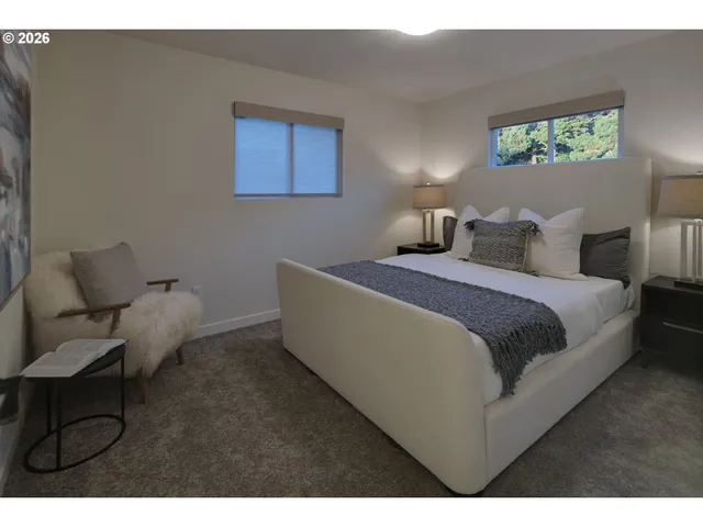 a bedroom with a bed and a chair