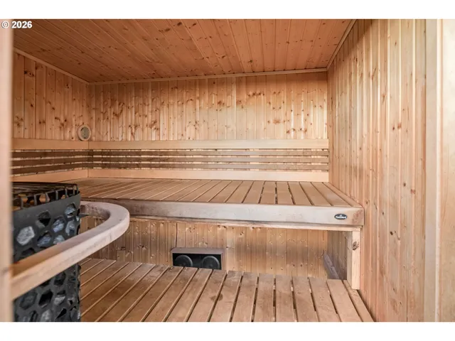 a picture of a room with wooden floor and furniture