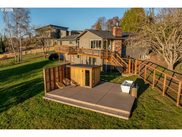 an aerial view of a house with a yard and lake view