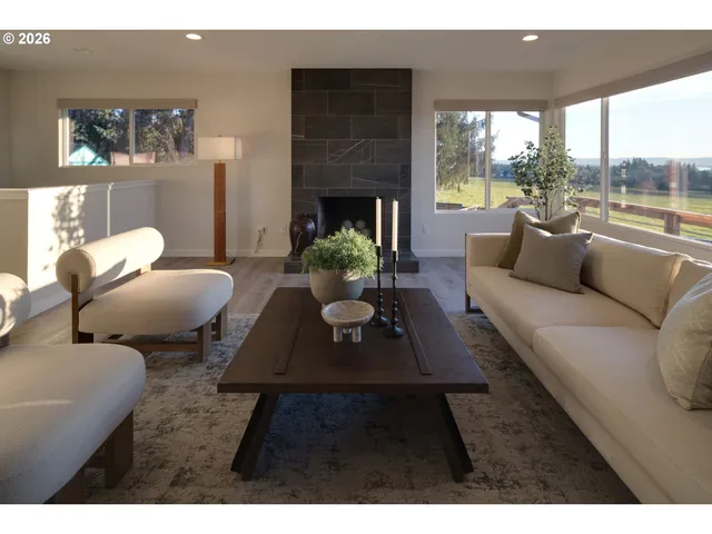 a living room with furniture fireplace and window