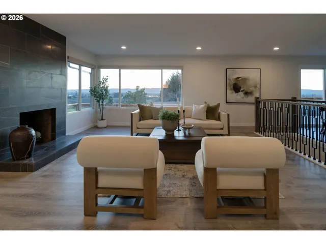 a living room with fireplace furniture and a floor to ceiling window