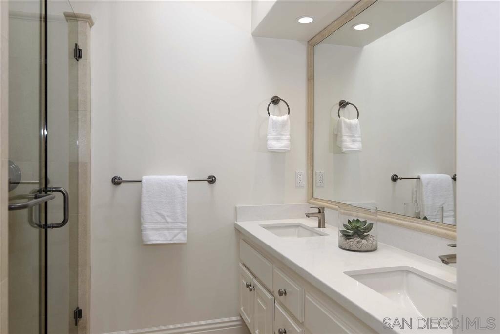 9660 Claiborne Square La Jolla, CA 92037 - Photo 20 of 23 a bathroom with a sink and mirror