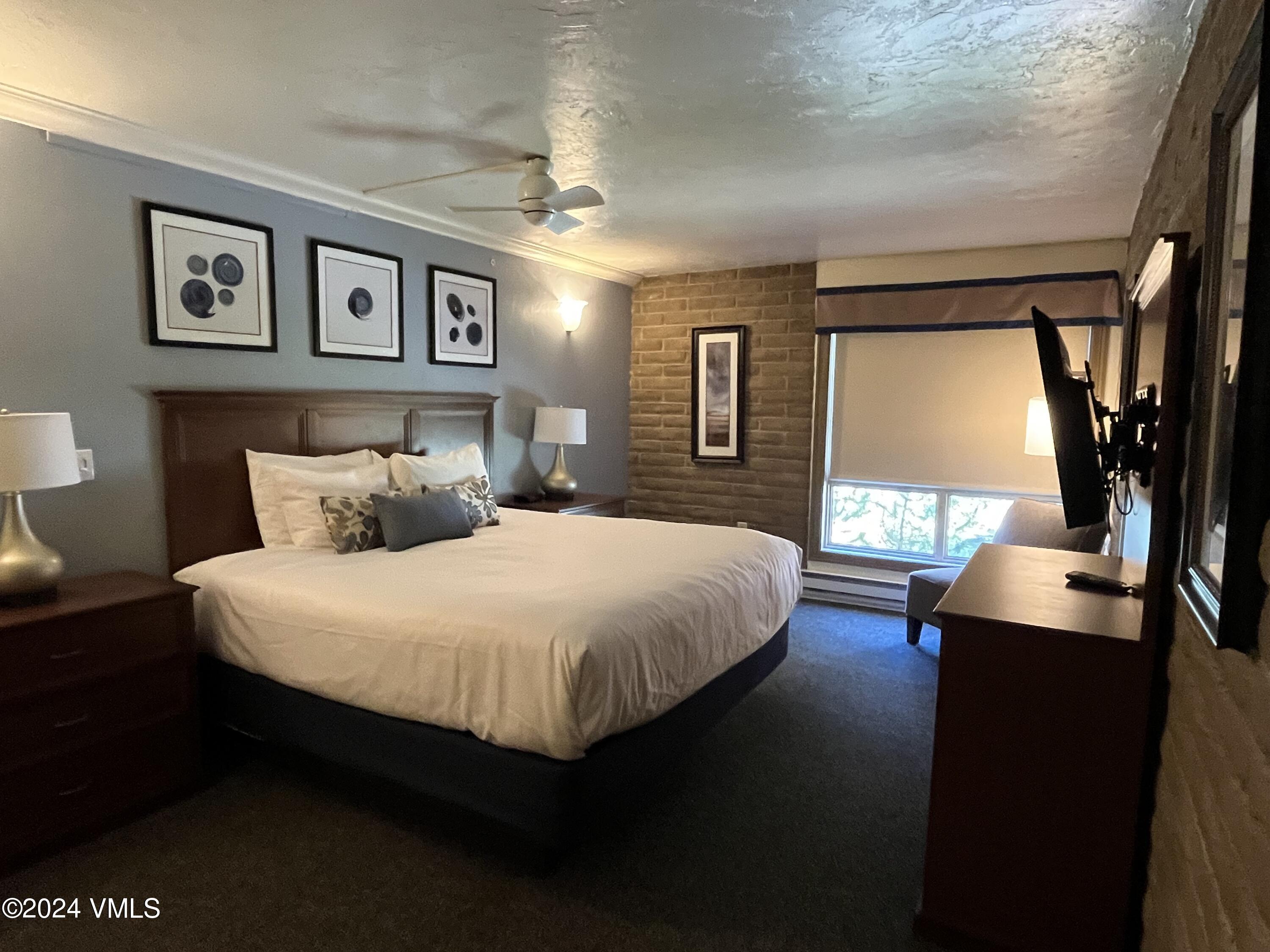 1020 Vail View Drive, Unit 120536 Vail, CO 81657 - Photo 8 of 23 a bedroom with a large bed and a chandelier