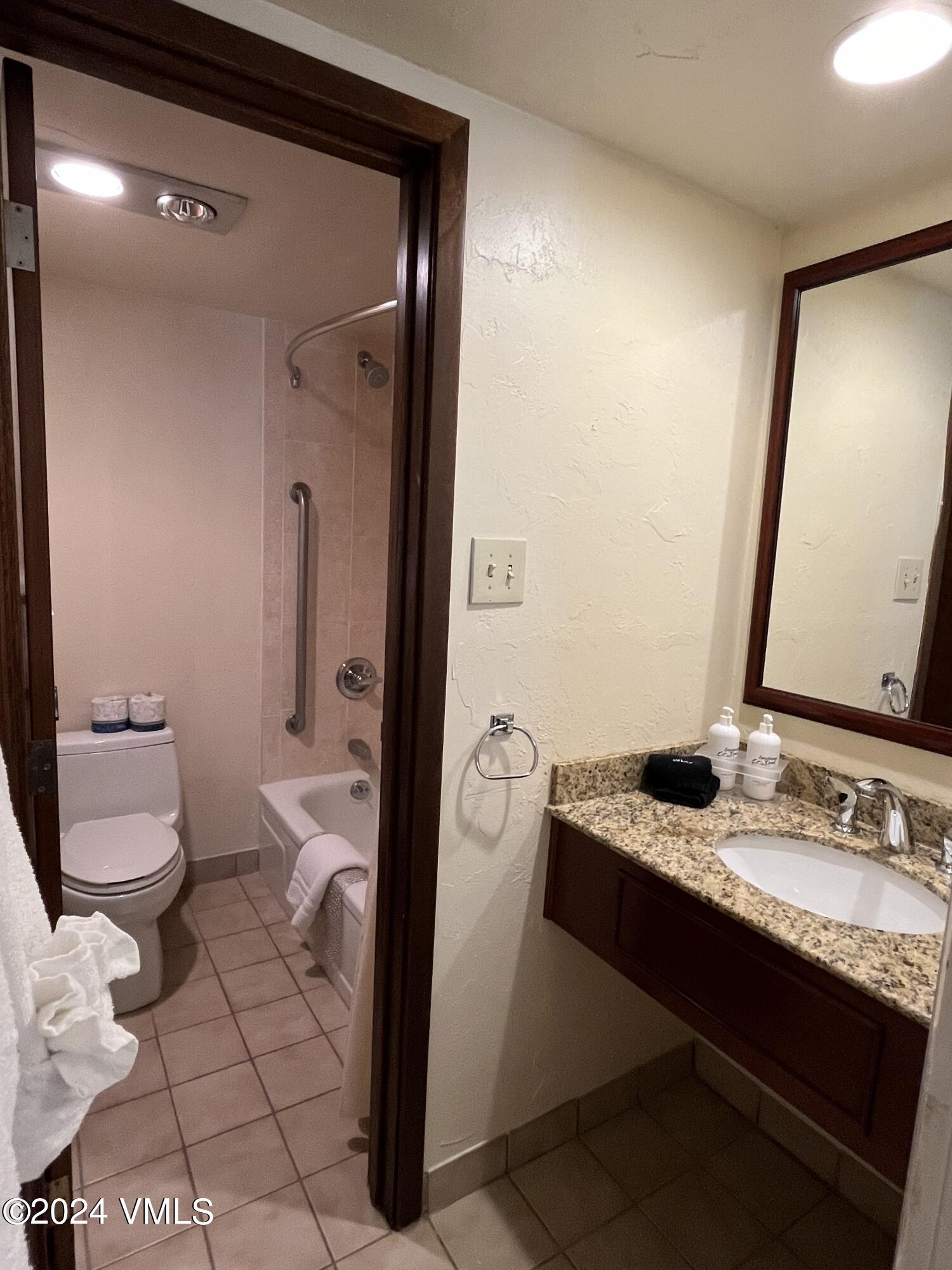1020 Vail View Drive, Unit 120536 Vail, CO 81657 - Photo 9 of 23 a bathroom with a granite countertop sink mirror vanity and toilet