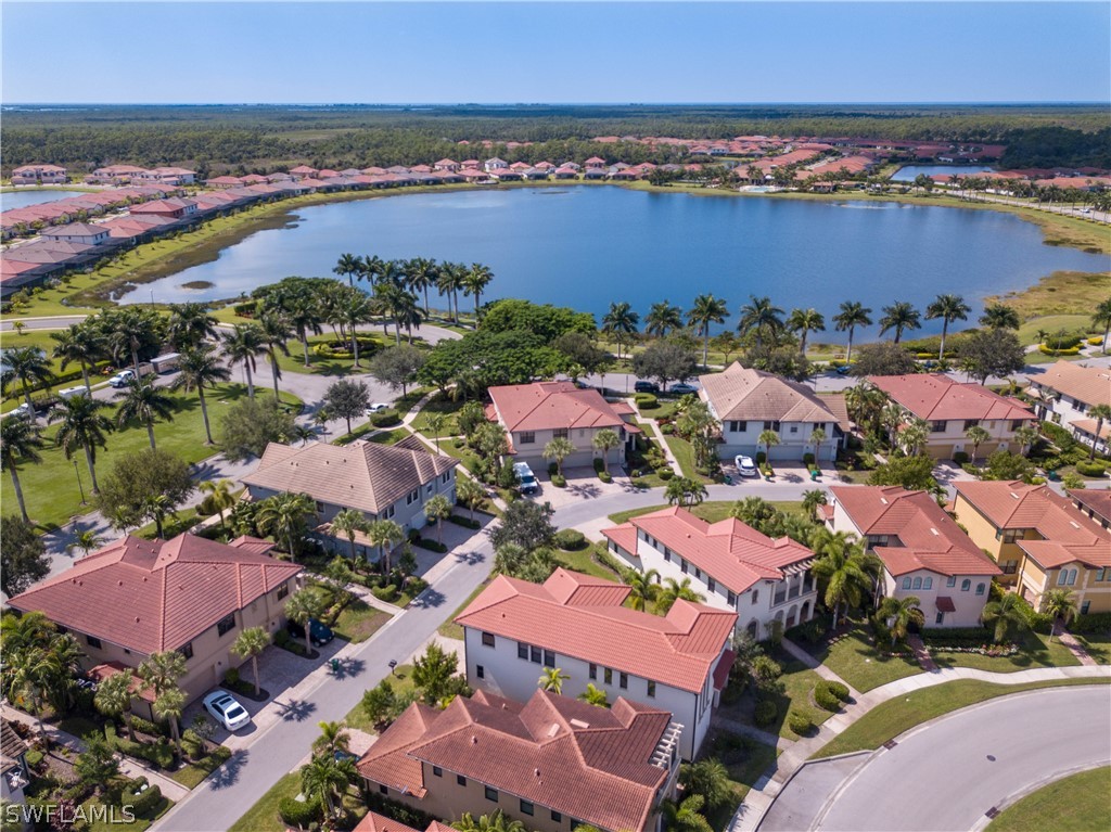 1387 Santiago Circle, Unit 802 Naples, FL 34113 - Photo 1 of 29 an aerial view of residential houses with outdoor space