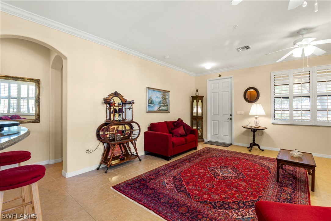 1387 Santiago Circle, Unit 802 Naples, FL 34113 - Photo 13 of 29 a living room with furniture rug and window
