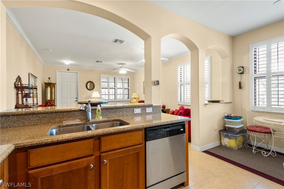 1387 Santiago Circle, Unit 802 Naples, FL 34113 - Photo 17 of 29 a kitchen with sink and window