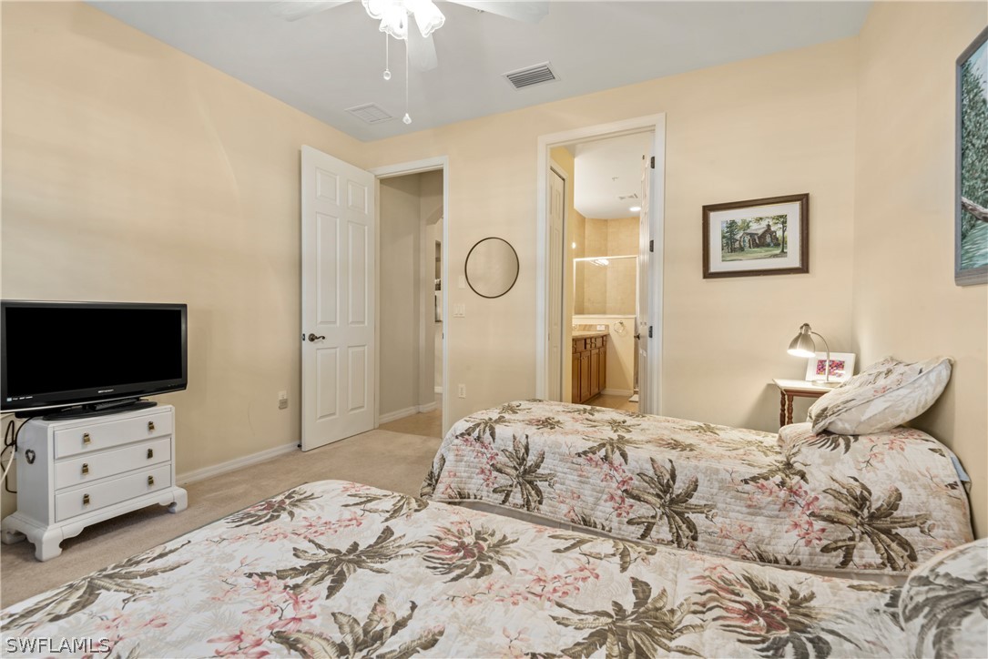 1387 Santiago Circle, Unit 802 Naples, FL 34113 - Photo 19 of 29 a bedroom with a bed and flat screen tv