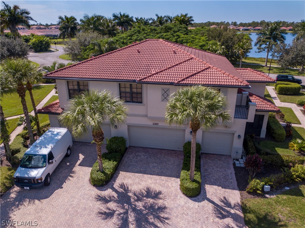 1387 Santiago Circle, Unit 802 Naples, FL 34113 - Photo 2 of 29 a view of a house with garden and plants