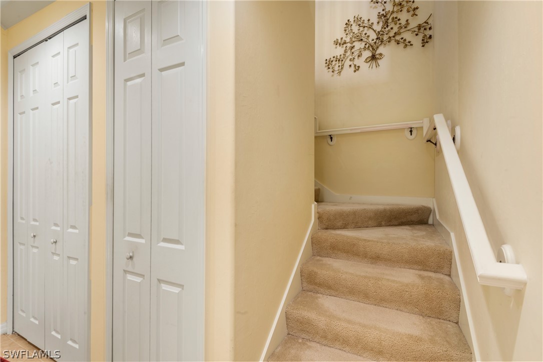 1387 Santiago Circle, Unit 802 Naples, FL 34113 - Photo 24 of 29 a view of staircase with white walls