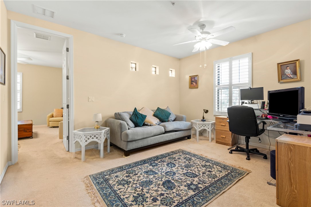 1387 Santiago Circle, Unit 802 Naples, FL 34113 - Photo 26 of 29 a living room with furniture rug and a flat screen tv