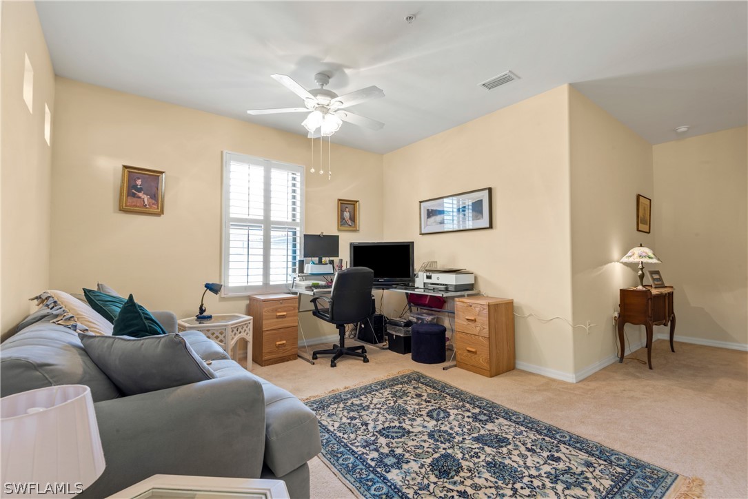 1387 Santiago Circle, Unit 802 Naples, FL 34113 - Photo 27 of 29 a living room with furniture and a window