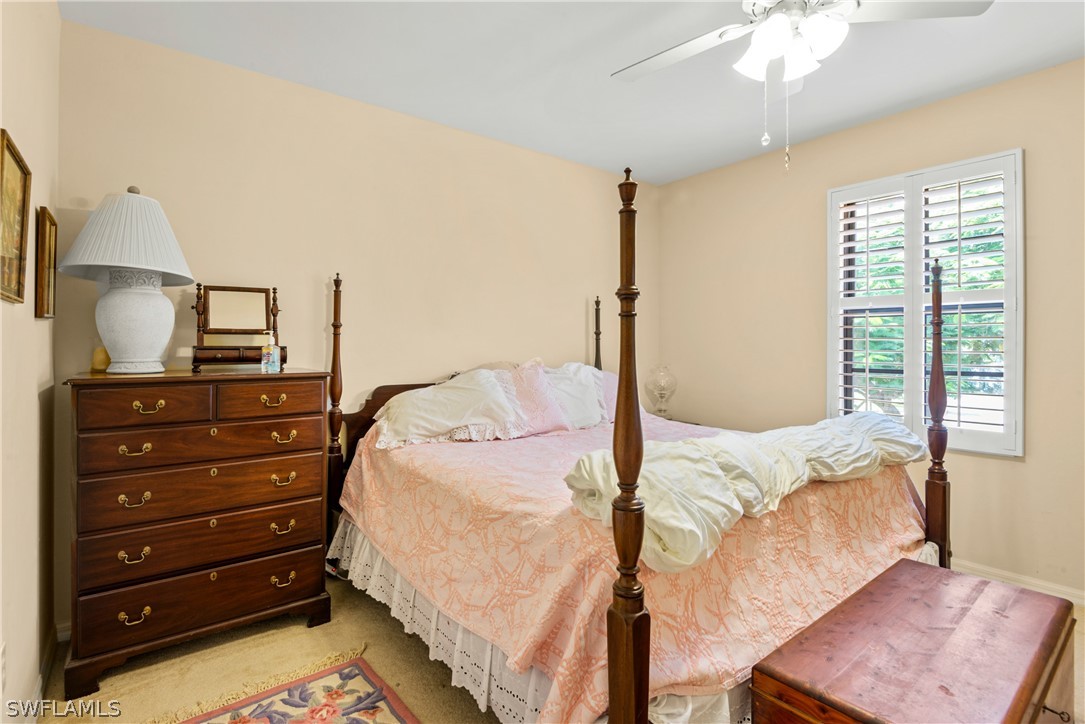 1387 Santiago Circle, Unit 802 Naples, FL 34113 - Photo 28 of 29 a bedroom with a bed and a dresser