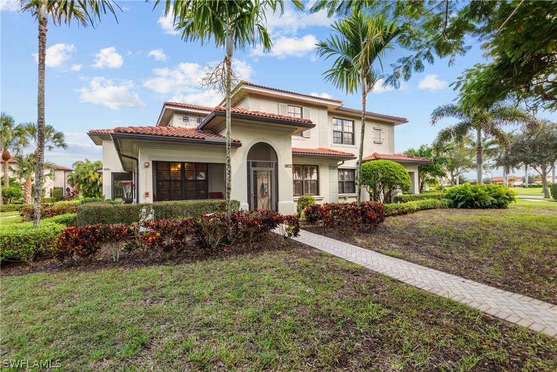 1387 Santiago Circle, Unit 802 Naples, FL 34113 - Photo 5 of 29 a front view of a house with a garden