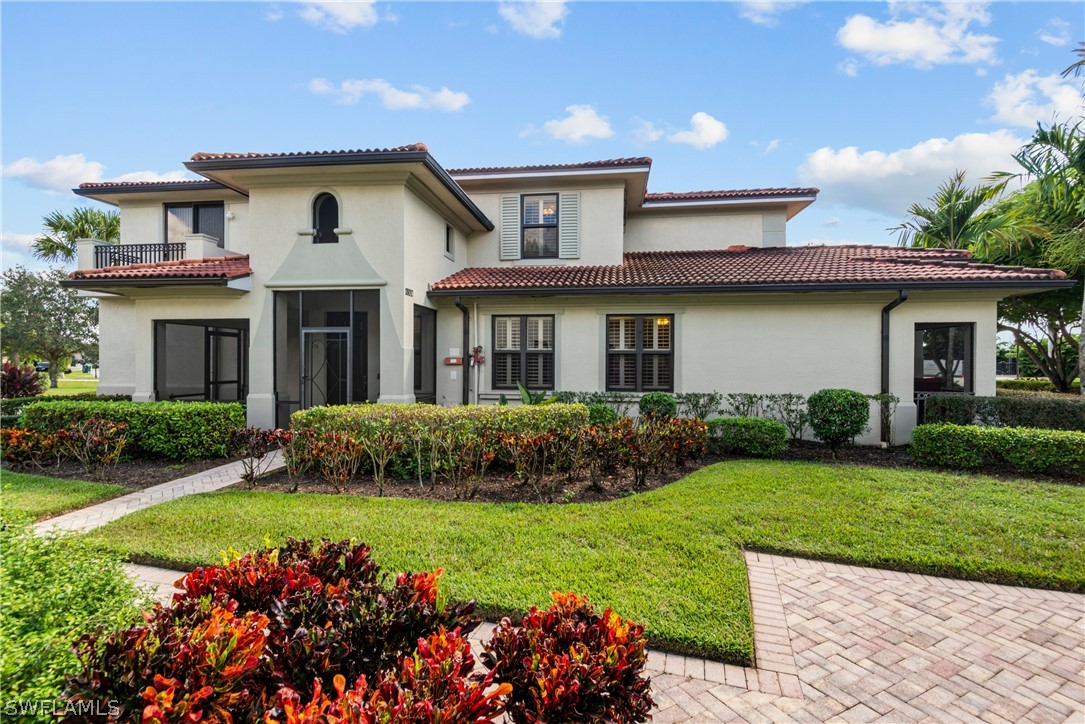 1387 Santiago Circle, Unit 802 Naples, FL 34113 - Photo 6 of 29 a front view of a house with a garden