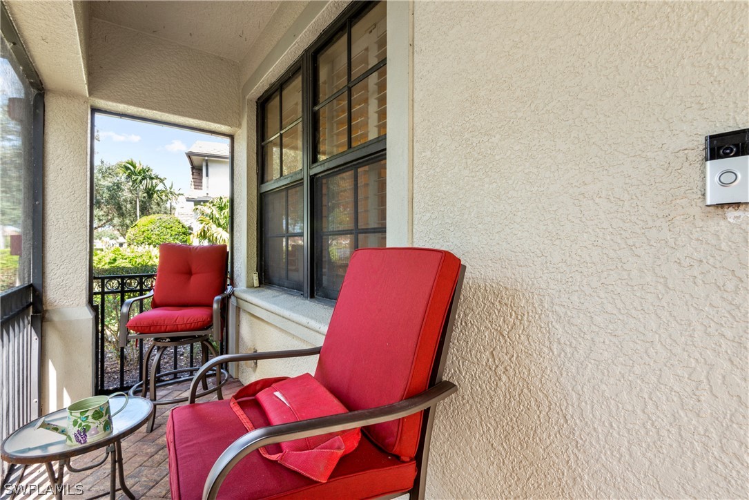 1387 Santiago Circle, Unit 802 Naples, FL 34113 - Photo 9 of 29 a living room with furniture and a large window