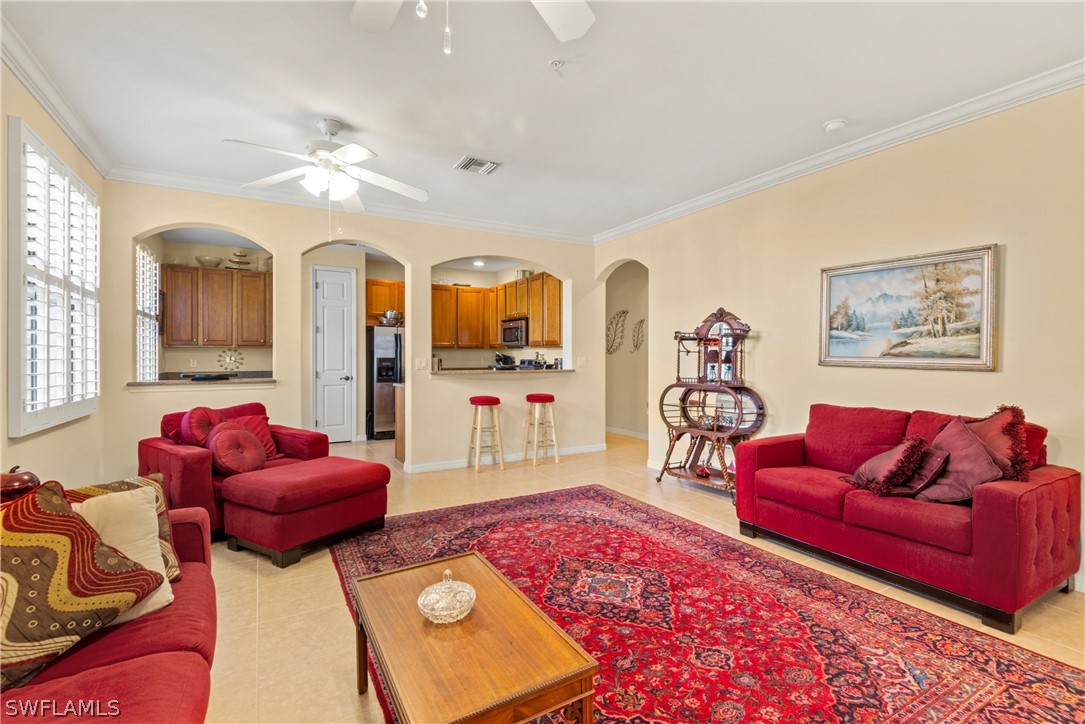 1387 Santiago Circle, Unit 802 Naples, FL 34113 - Photo 10 of 29 a living room with furniture and a chandelier