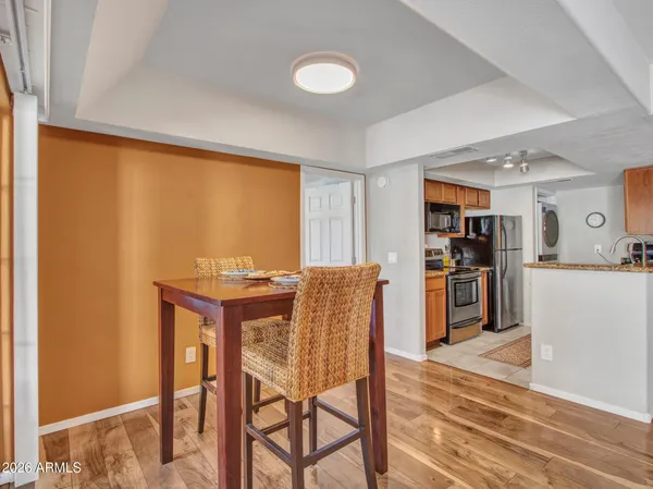 a kitchen with a refrigerator and a stove top oven