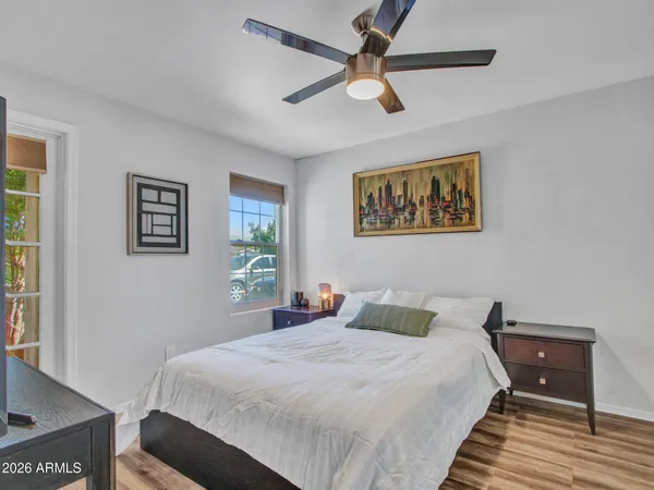 a bedroom with a bed and wooden floor