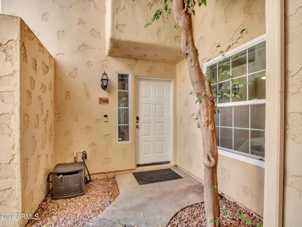 a living room with furniture and large windows
