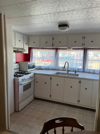 a view of a hallway view with wooden floor and staircase