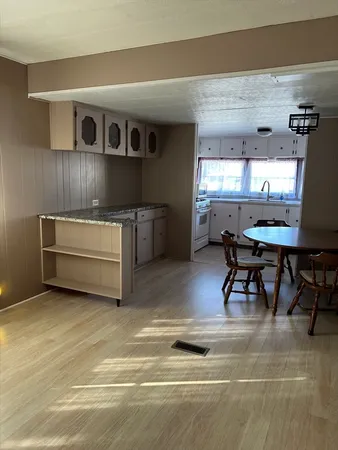 a kitchen with cabinets appliances and a window