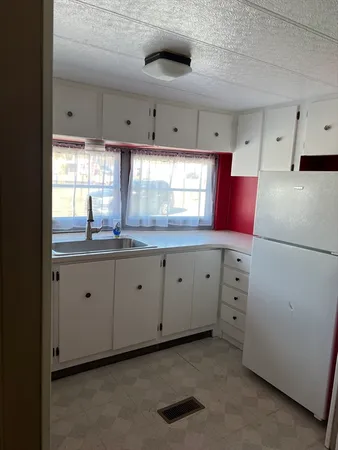 a kitchen with granite countertop a sink stainless steel appliances and cabinets