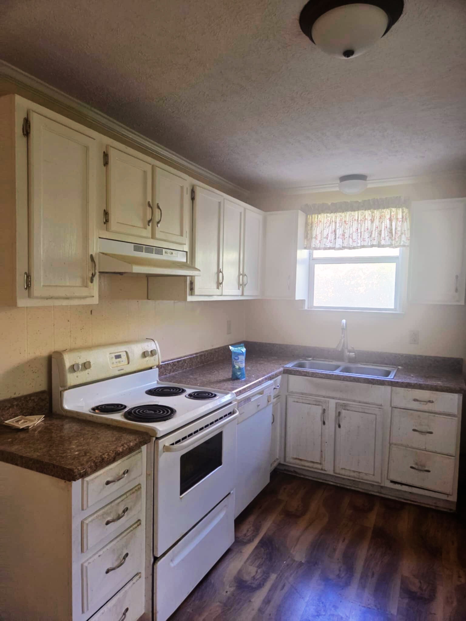 203 East 22nd Avenue Springfield, TN 37172 - Photo 3 of 8 a kitchen with granite countertop white cabinets and white appliances