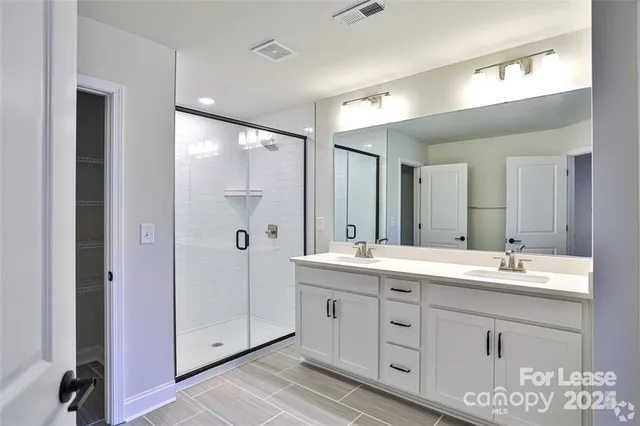 a spacious bathroom with a double vanity sink mirror and double