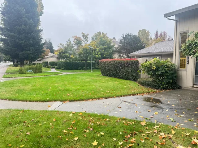 a view of a kitchen with a sink and a refrigerator