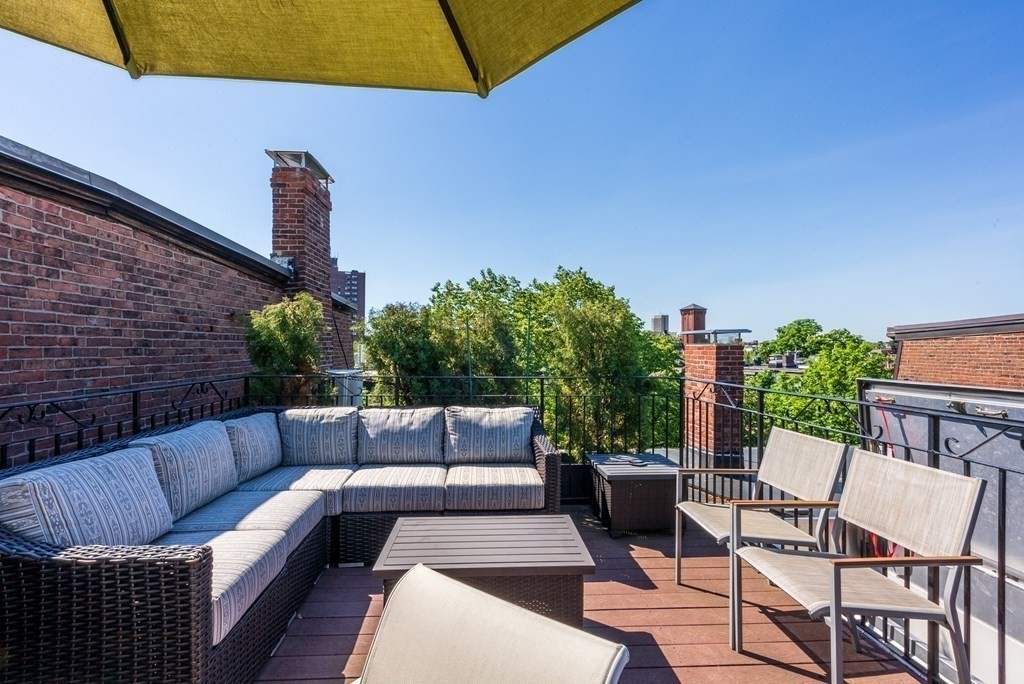 75 Montgomery Street, Unit 4 Boston, MA 02116 - Photo 3 of 14 a view of a patio with couches and potted plants
