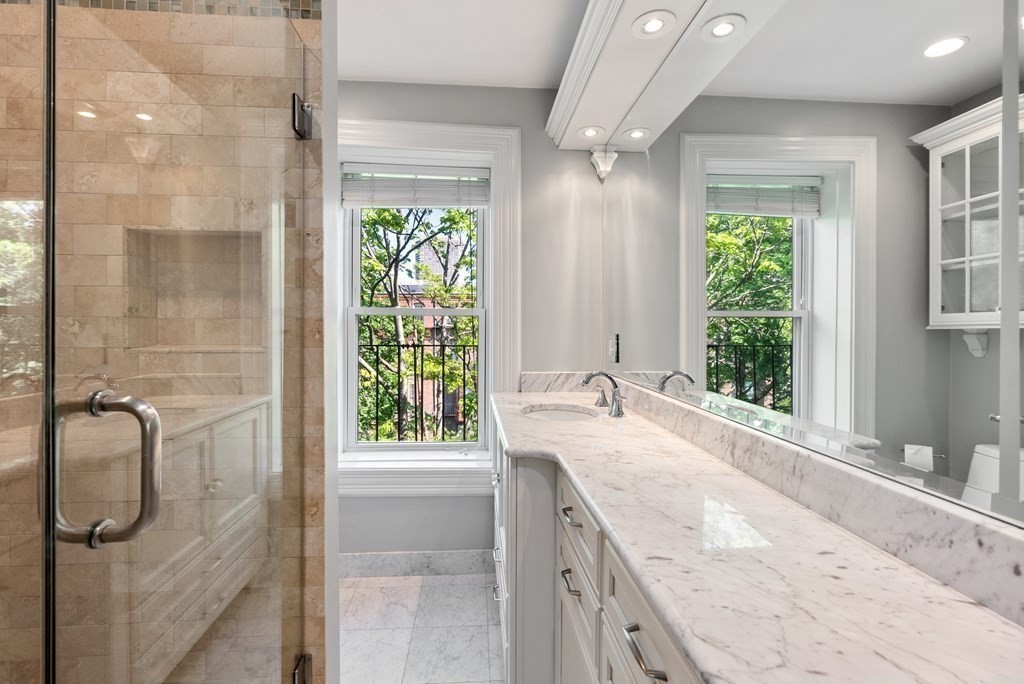 75 Montgomery Street, Unit 4 Boston, MA 02116 - Photo 6 of 14 a bathroom with a granite countertop sink and a shower
