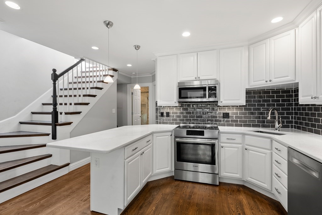 75 Montgomery Street, Unit 4 Boston, MA 02116 - Photo 10 of 14 a kitchen with a sink a stove and oven