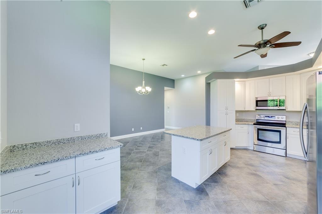 190 San Rafael Lane Naples, FL 34119 - Photo 8 of 32 a kitchen with granite countertop a sink and cabinets