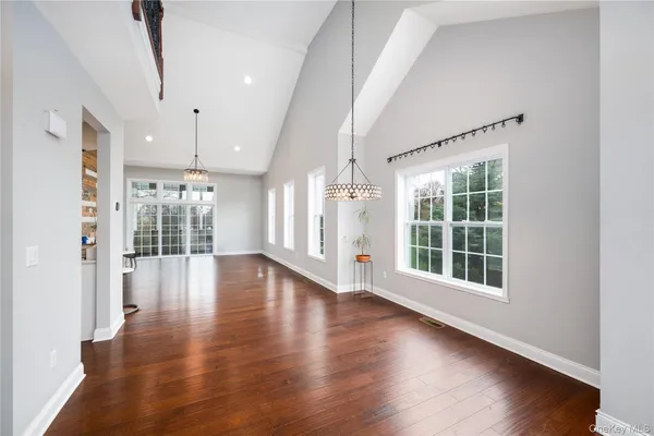 a dining room with furniture window and wooden floor