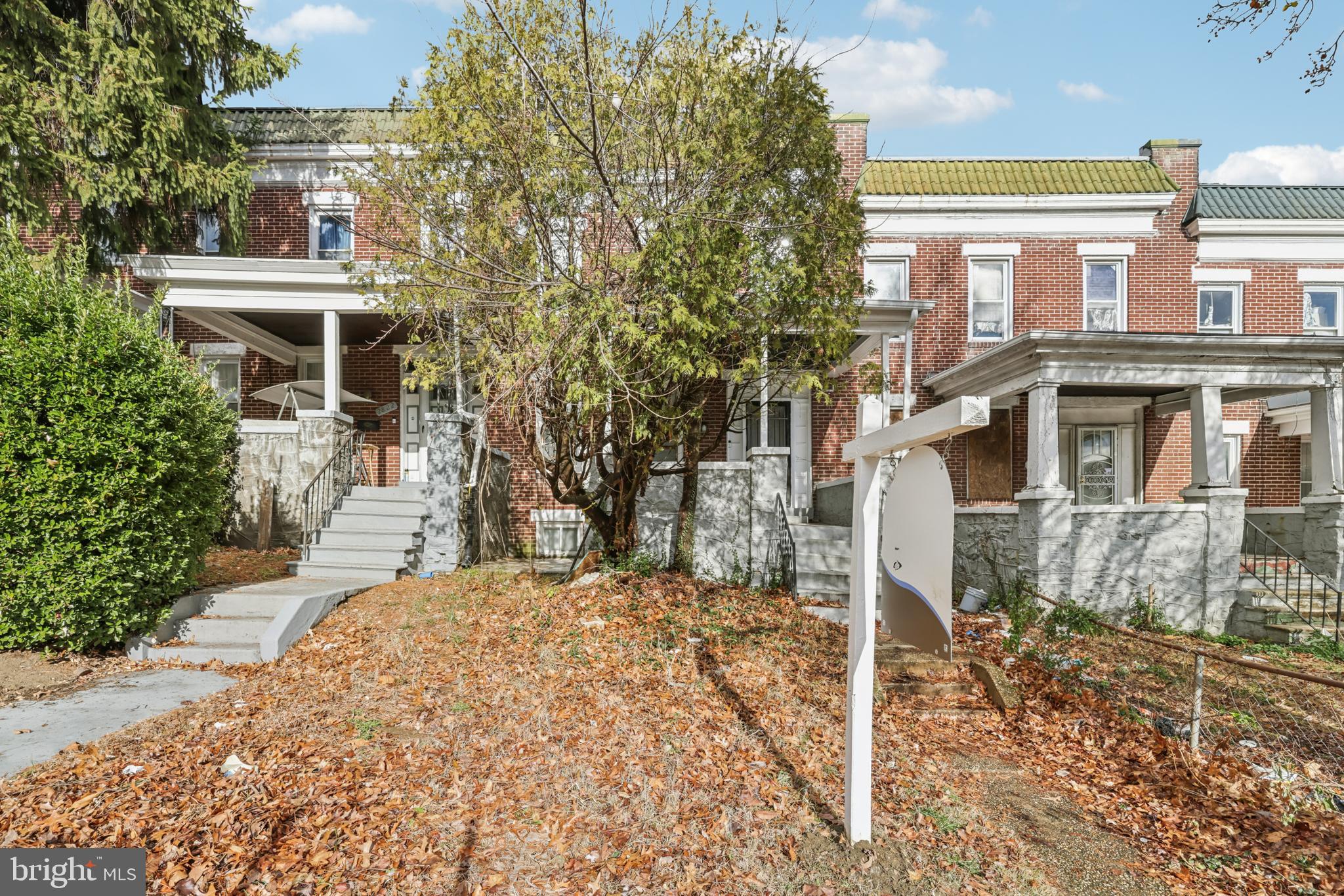 2820 Brighton Street Baltimore, MD 21216 - Photo 2 of 38 a front view of a house with a yard
