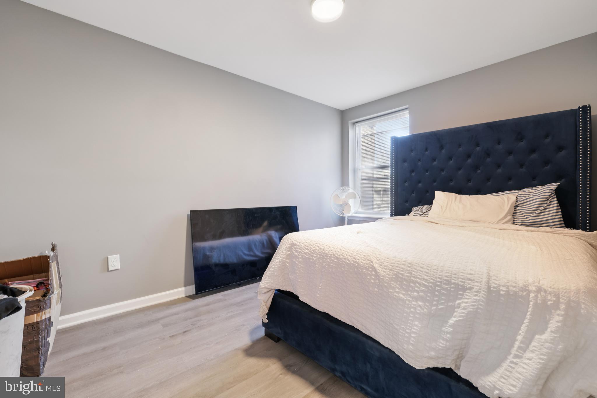 2820 Brighton Street Baltimore, MD 21216 - Photo 24 of 38 a bedroom with a bed and wooden floor