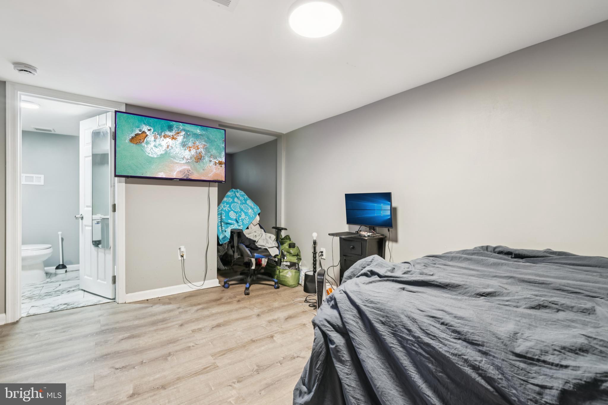 2820 Brighton Street Baltimore, MD 21216 - Photo 26 of 38 a bedroom with a bed and a flat screen tv