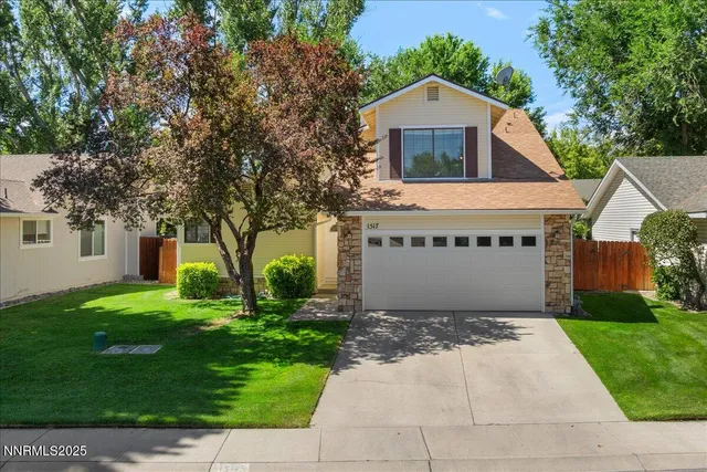a front view of house with yard and green space