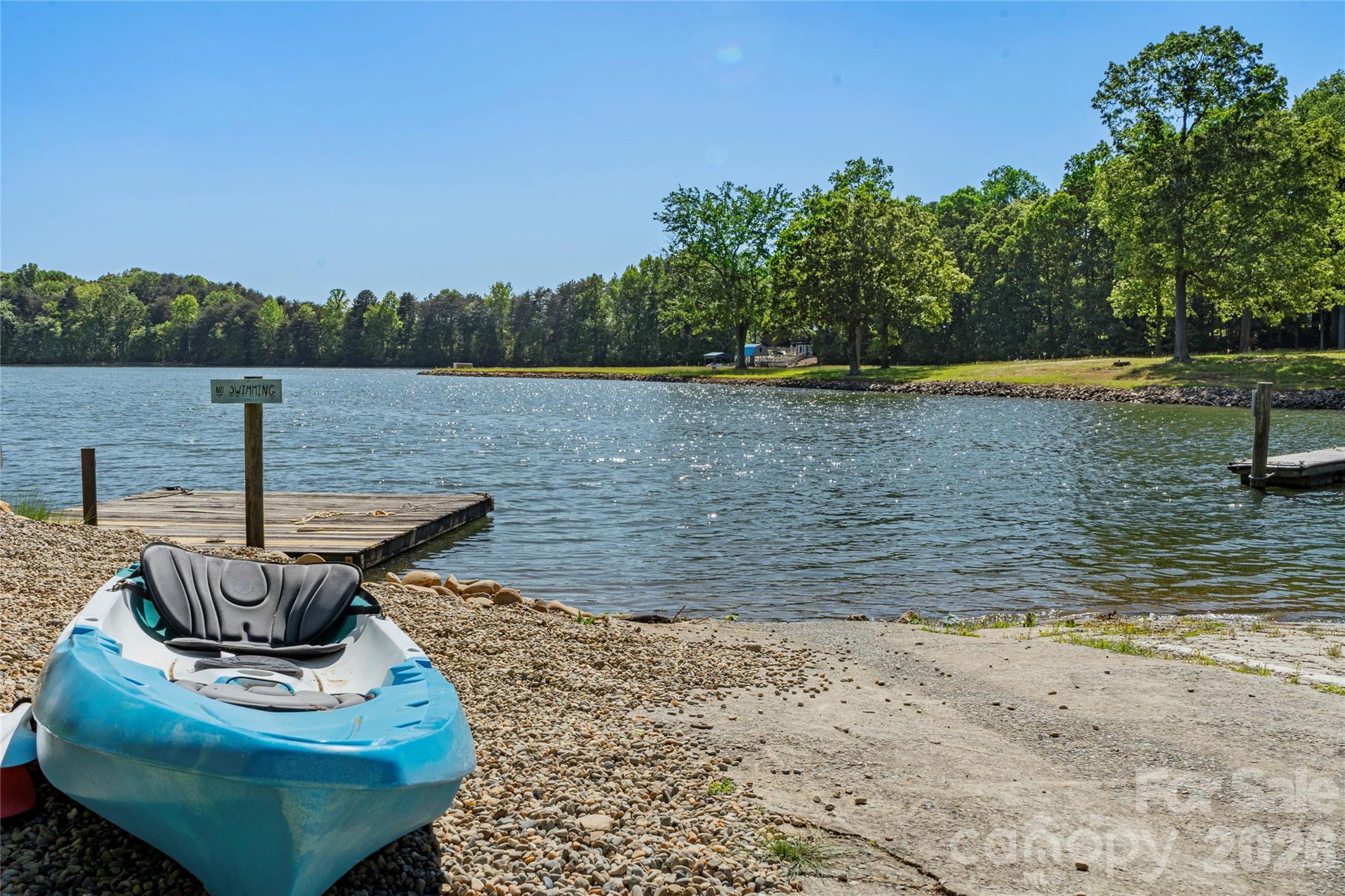 1100 Arundle Road Sherrills Ford, NC 28673 - Photo 32 of 35 a view of a lake with a bench and trees in the background