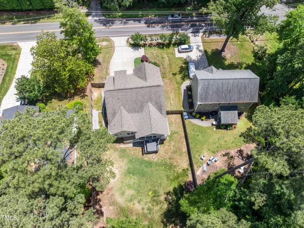 an aerial view of a house with swimming pool and garden