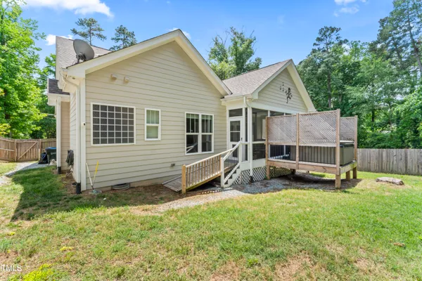 a view of a house with a yard and sitting area