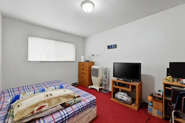 a bedroom with a bed and a couch