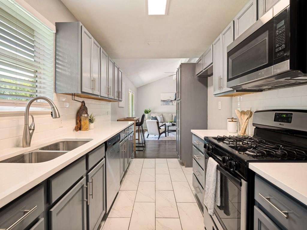 1405 Rambler Road Arlington, TX 76014 - Photo 12 of 26 Galley kitchen featuring gray cabinetry, white countertops, tile flooring, stainless steel appliances, and a subway tile backsplash
