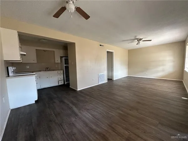 a view of a kitchen with a sink and a stove top oven