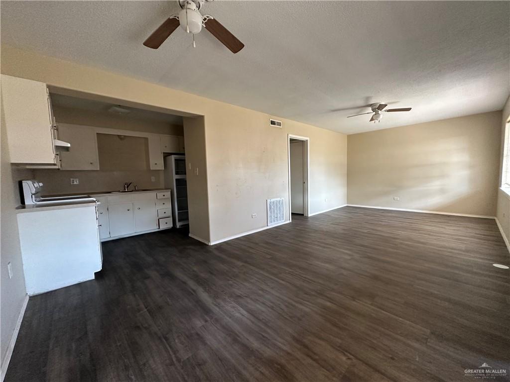 1809 West Kuhn Street Edinburg, TX 78541 - Photo 2 of 5 a view of a kitchen with a sink and a stove top oven