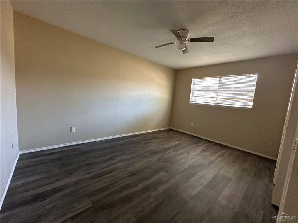 1809 West Kuhn Street Edinburg, TX 78541 - Photo 5 of 5 an empty room with wooden floor fan and windows